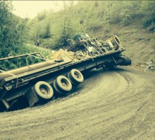 A low bed truck slips off the road at 10 Mile